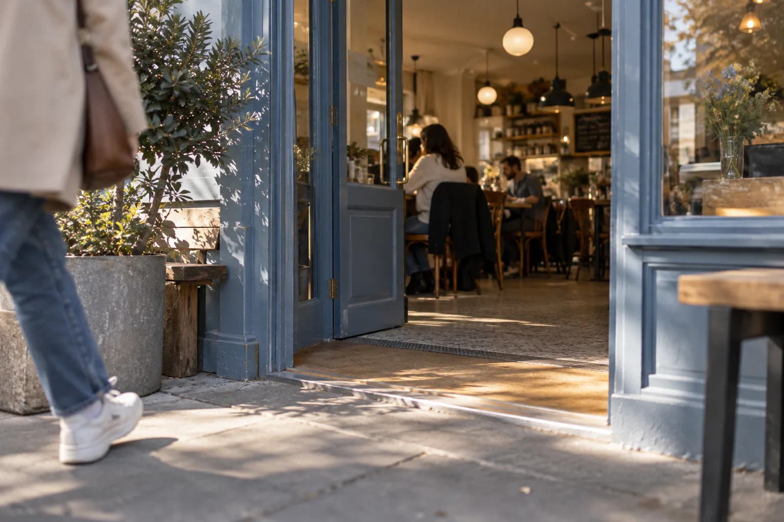 The entrance of a neighborhood cafe viewed from the sidewalk.