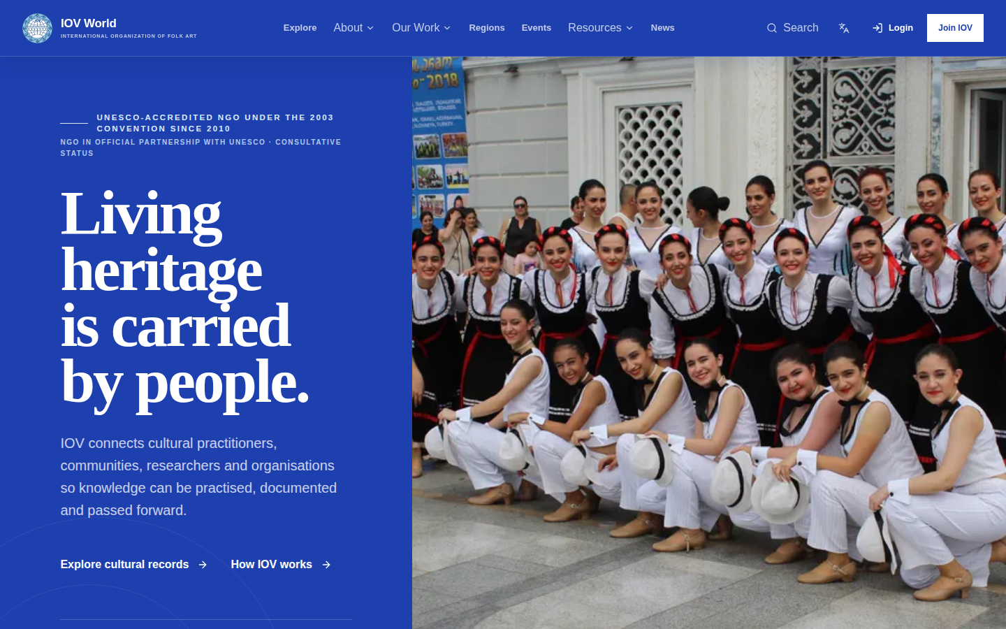 The public IOV World homepage, with the headline Living heritage is carried by people and a photograph of a folk-dance ensemble.